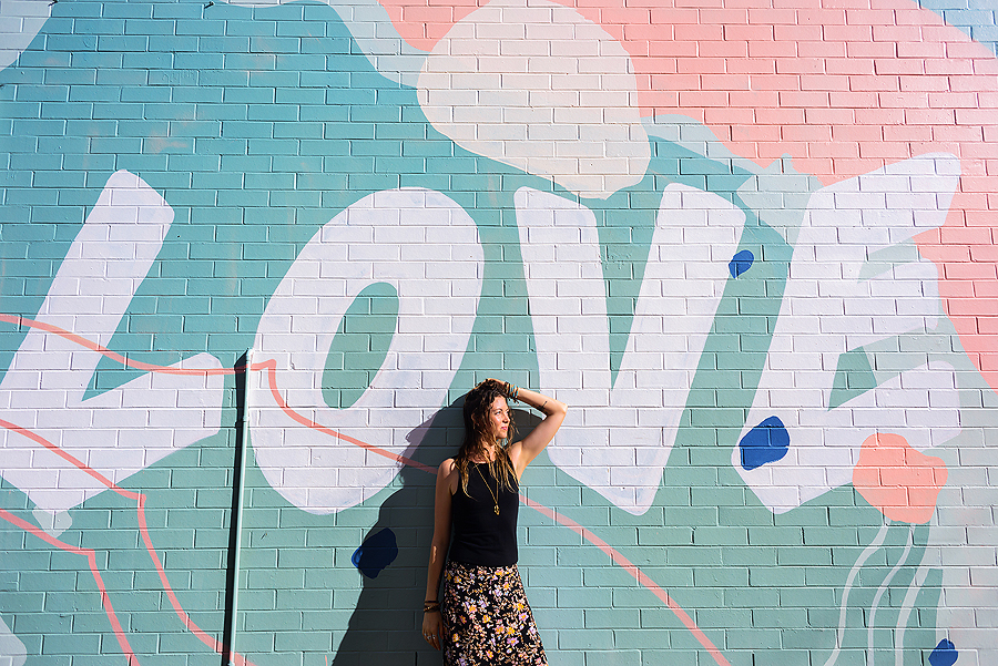 Lady standing against love wall for personal branding photogaphy by Sunshine Coast photographer Elise Gow